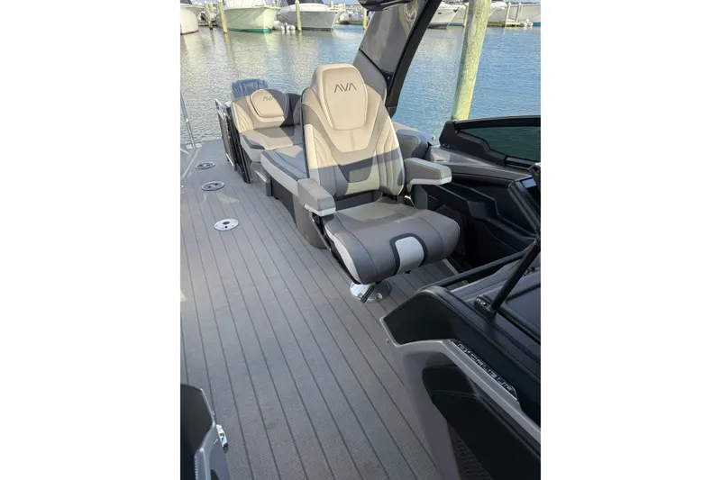Slide: The Image of Luxurious seating on 2025 Avalon Excalibur Quad Lounge Windshield boat at marina. - 36