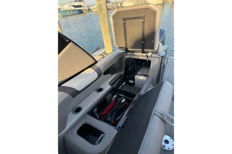 Slide: The Image of 2025 Avalon Excalibur Quad Lounge Windshield boat interior with open storage compartments. - 41