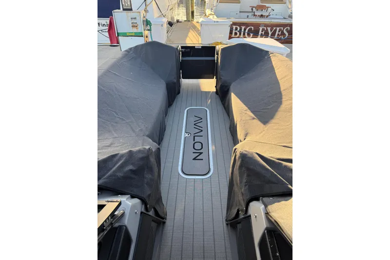 Slide: The Image of 2025 Avalon Excalibur Quad Lounge Windshield boat interior with covered seating. - 43