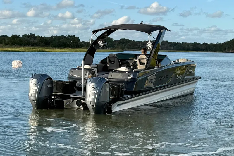 Slide: The Image of 2025 Avalon Excalibur Quad Lounge Windshield boat on water, featuring dual Yamaha 300 V6 engines. - 6