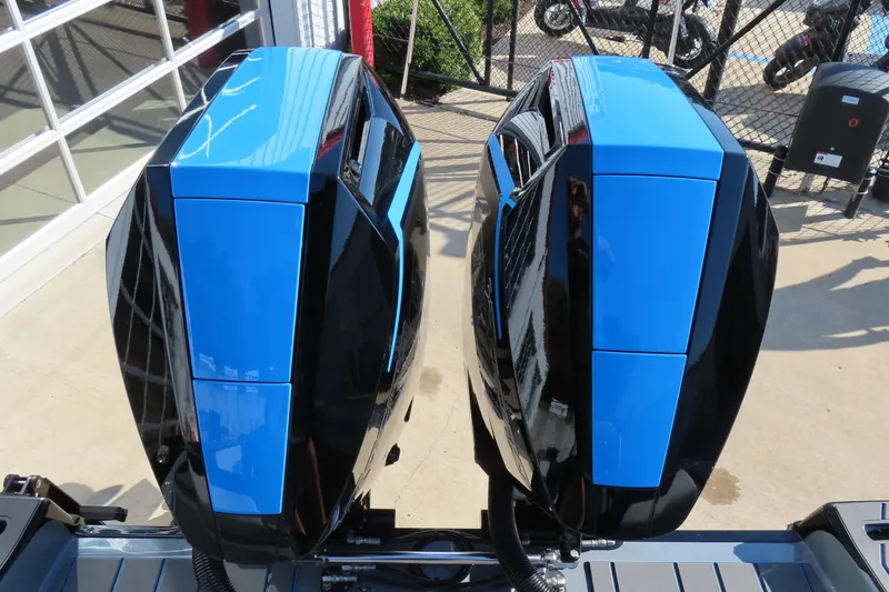 Slide: The Image of 2026 Sunsation 32 CCX boat engines, sleek black and blue design, outdoor display. - 20