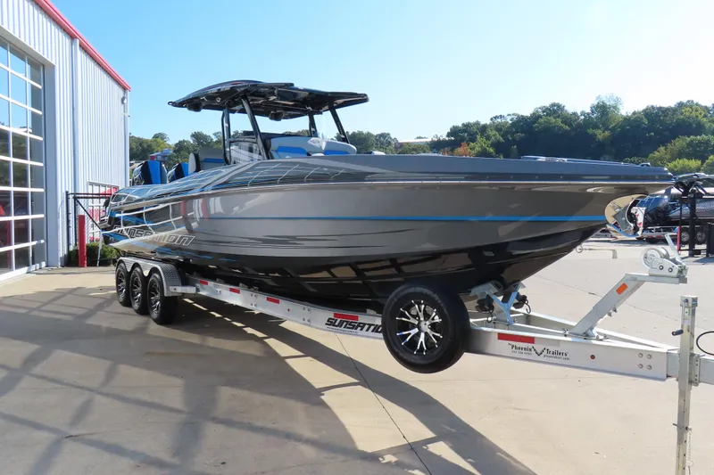 Slide: The Image of 2026 Sunsation 32 CCX boat on trailer, sleek design, parked outdoors. - 3