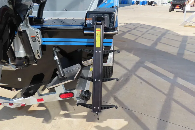 Slide: The Image of 2026 Sunsation 32 CCX boat trailer with hydraulic components and safety features. - 6