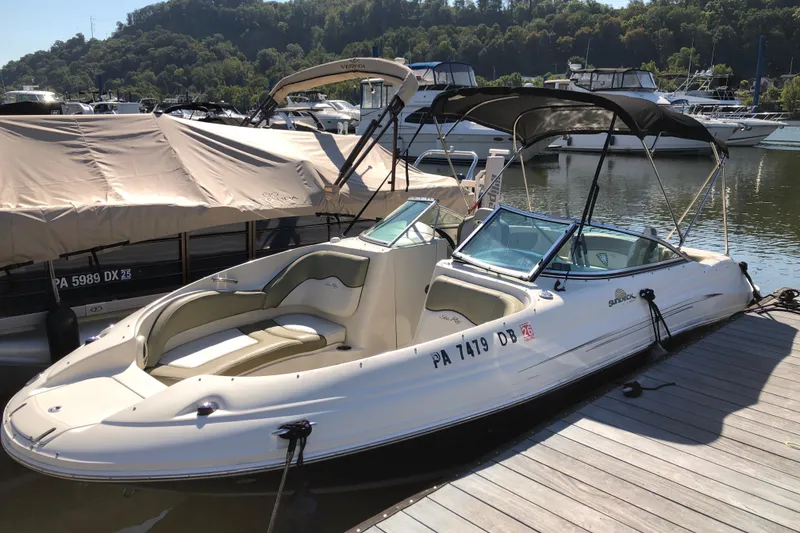 The Image of 2007 Sea Ray 220 Sundeck boat docked at marina, surrounded by other boats. - 1