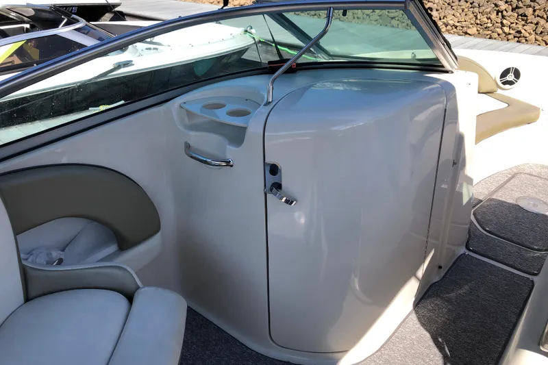 Slide: The Image of 2007 Sea Ray 220 Sundeck interior with seating and cup holders, showcasing sleek design. - 10