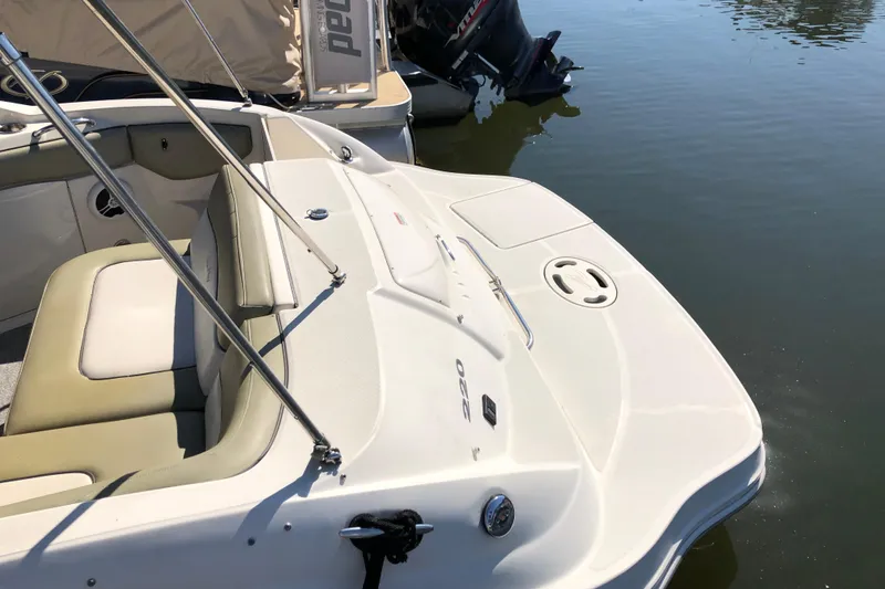 Slide: The Image of 2007 Sea Ray 220 Sundeck boat with beige seating, docked on calm water. - 3