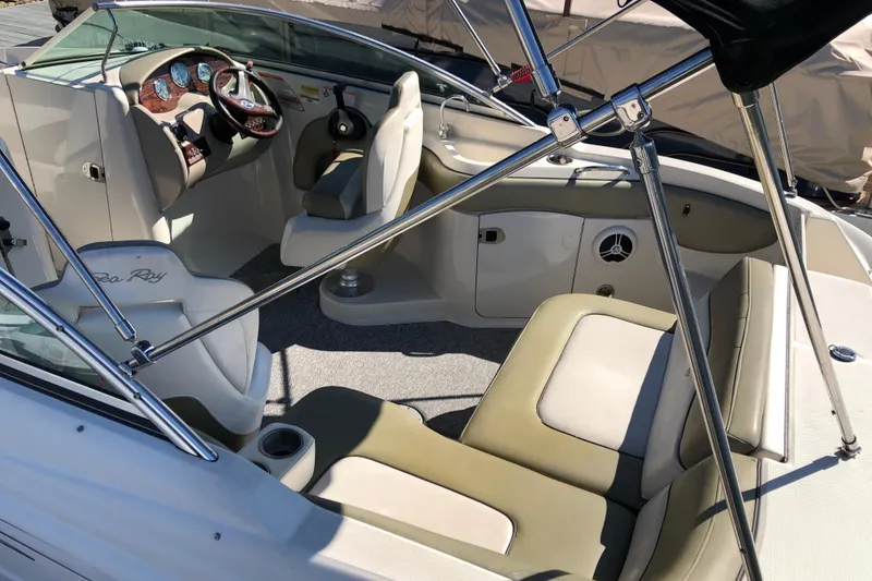 Slide: The Image of 2007 Sea Ray 220 Sundeck interior with beige seating and sleek dashboard design. - 4