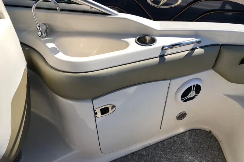 Slide: The Image of 2007 Sea Ray 220 Sundeck interior with sink, speaker, and storage compartment. - 7