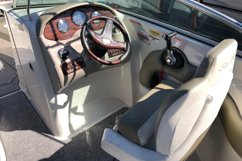 Slide: The Image of 2007 Sea Ray 220 Sundeck boat cockpit with steering wheel and control panel. - 8