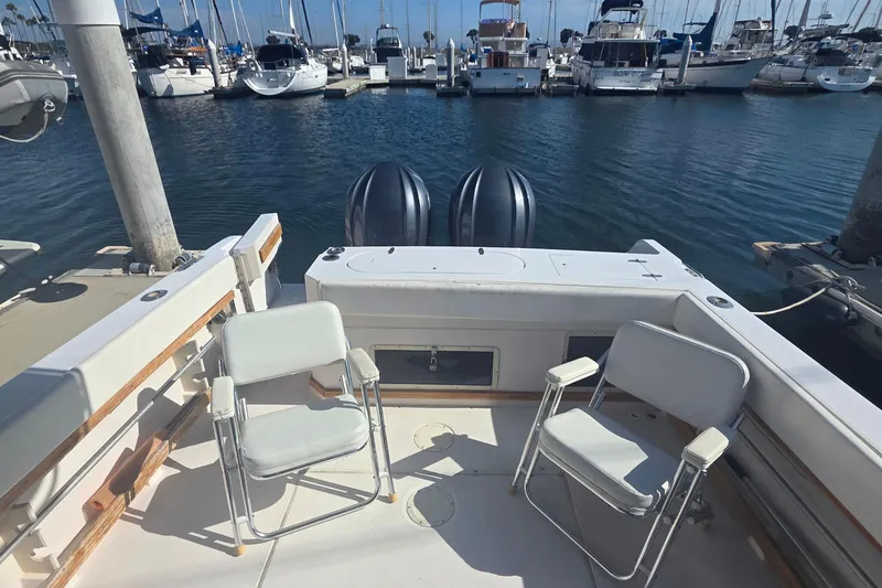 Slide: The Image of 1990 Grady-White Marlin 280 boat interior with chairs, docked at marina. - 18