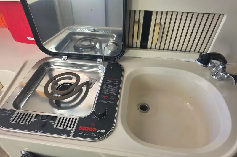 Slide: The Image of Grady-White Marlin 280 (1990) boat kitchen with Origo 2500 stove and sink. - 26