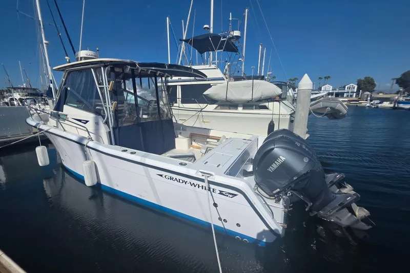 Slide: The Image of 1990 Grady-White Marlin 280 boat docked with Yamaha outboard motor. - 6