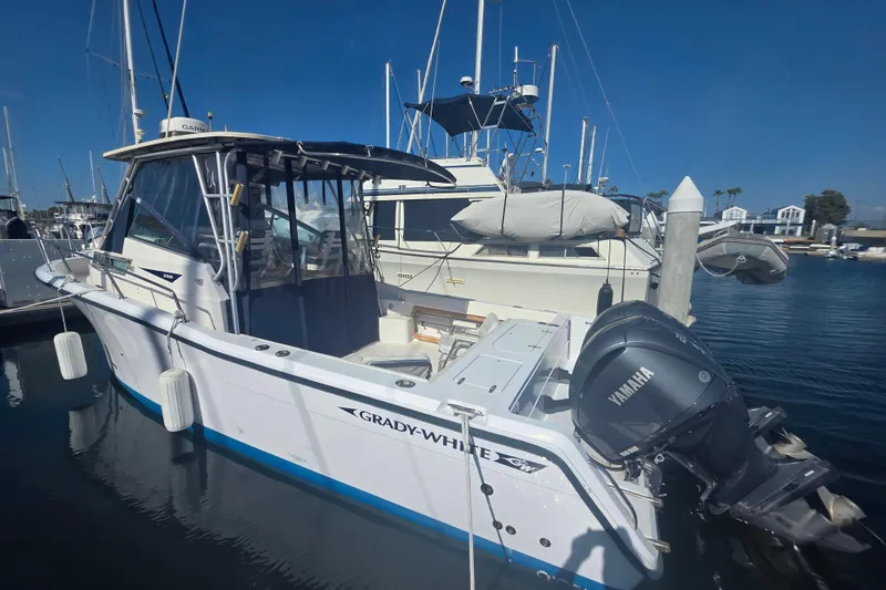 Slide: The Image of 1990 Grady-White Marlin 280 boat docked with Yamaha outboard motor. - 7