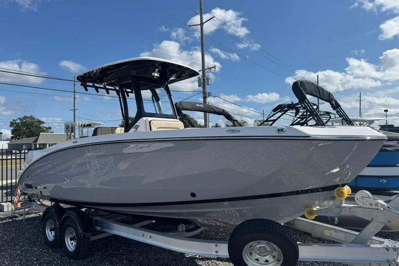 The Image of 2026 Yamaha Boats 255 FSH Sport H on trailer under clear blue sky. - 0