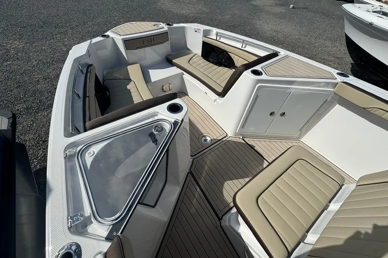 Slide: The Image of Interior view of 2026 Yamaha Boats 255 FSH Sport H, featuring helm and seating. - 10