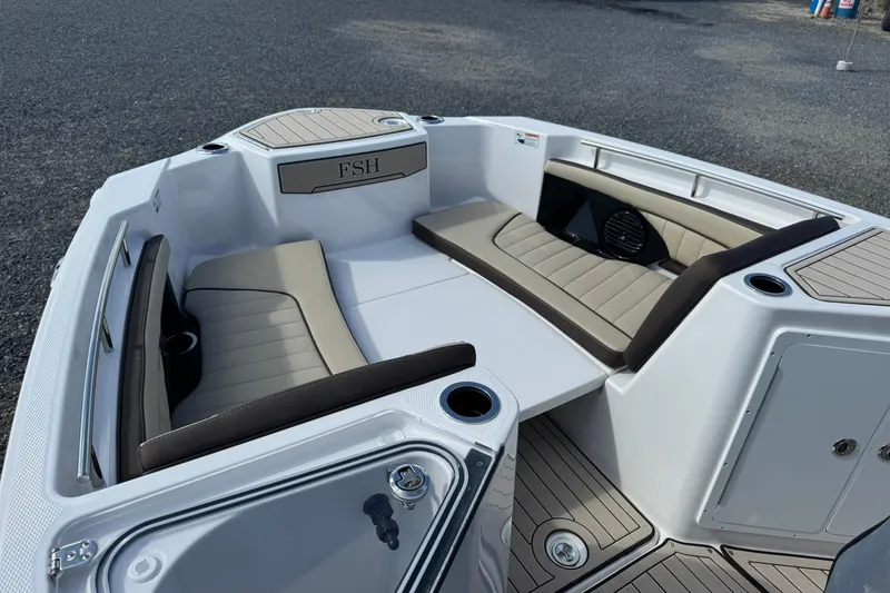 Slide: The Image of 2026 Yamaha Boats 255 FSH Sport H interior with beige seating and storage compartments. - 11