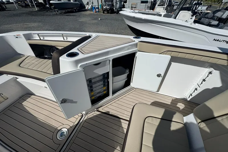 Slide: The Image of 2026 Yamaha Boats 255 FSH Sport H interior with cushioned seating and sleek design. - 12