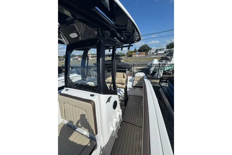 Slide: The Image of 2026 Yamaha Boats 255 FSH Sport H interior with cushioned seating and sleek design. - 15