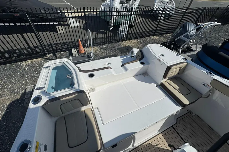 Slide: The Image of 2026 Yamaha Boats 255 FSH Sport H interior with seating and console, outdoor setting. - 16