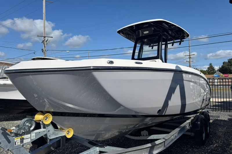 Slide: The Image of 2026 Yamaha Boats 255 FSH Sport H on trailer under blue sky. - 3