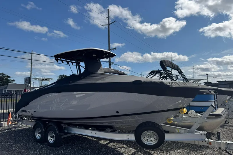 Slide: The Image of 2026 Yamaha Boats 255 FSH Sport H on trailer under clear blue sky. - 4