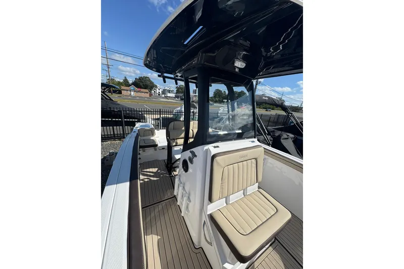Slide: The Image of 2026 Yamaha Boats 255 FSH Sport H interior with open storage compartment. - 7