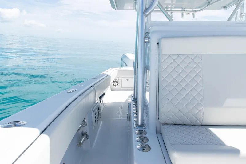 Slide: The Image of 2006 SeaVee 340B boat interior with quilted seating, on calm ocean waters. - 13