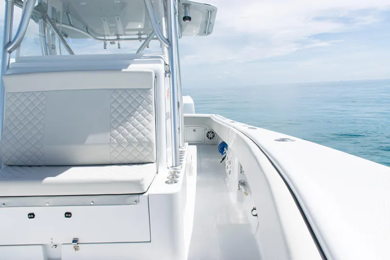 Slide: The Image of 2006 SeaVee 340B boat interior with white seating, ocean view, and clear sky. - 14