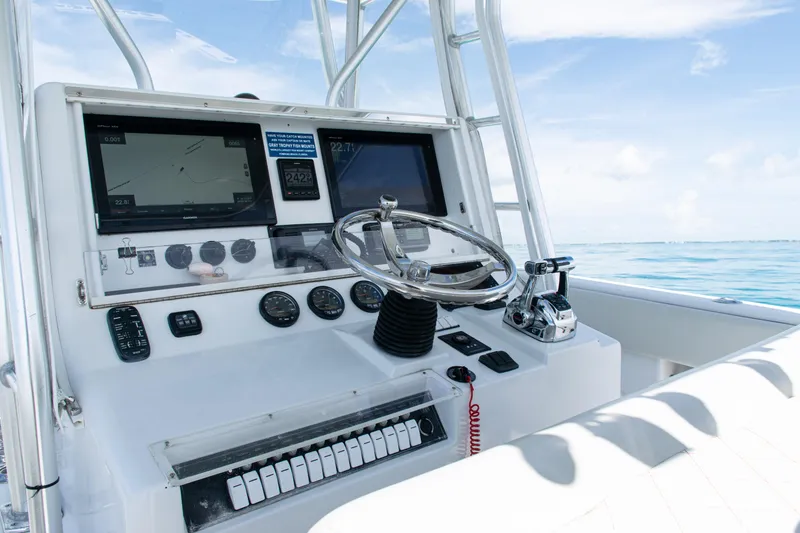 Slide: The Image of 2006 SeaVee 340B boat dashboard with steering wheel and navigation screens. - 17