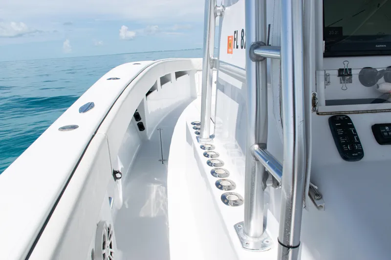 Slide: The Image of 2006 SeaVee 340B boat deck with rod holders, ocean view, and control panel. - 22