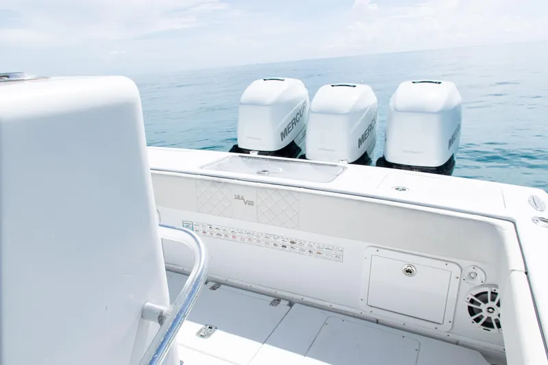 Slide: The Image of 2006 SeaVee 340B boat with triple Mercury Verado engines on calm ocean. - 26