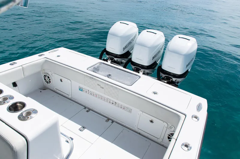 Slide: The Image of 2006 SeaVee 340B boat with triple Mercury engines on clear blue water. - 27