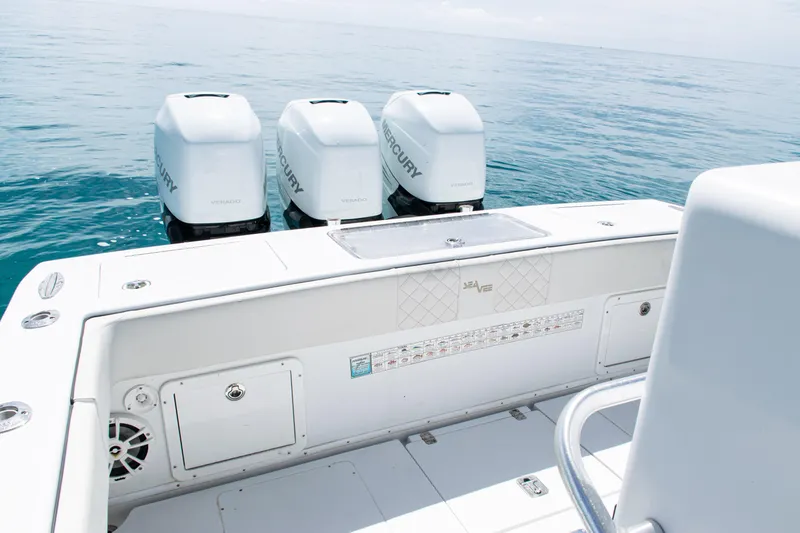Slide: The Image of 2006 SeaVee 340B boat with triple Mercury engines on open water. - 28