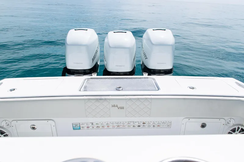 Slide: The Image of 2006 SeaVee 340B boat with triple Mercury Verado engines on calm ocean water. - 29