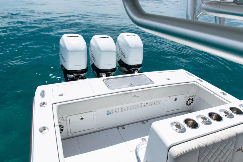 Slide: The Image of 2006 SeaVee 340B boat with triple Mercury engines on clear blue water. - 31