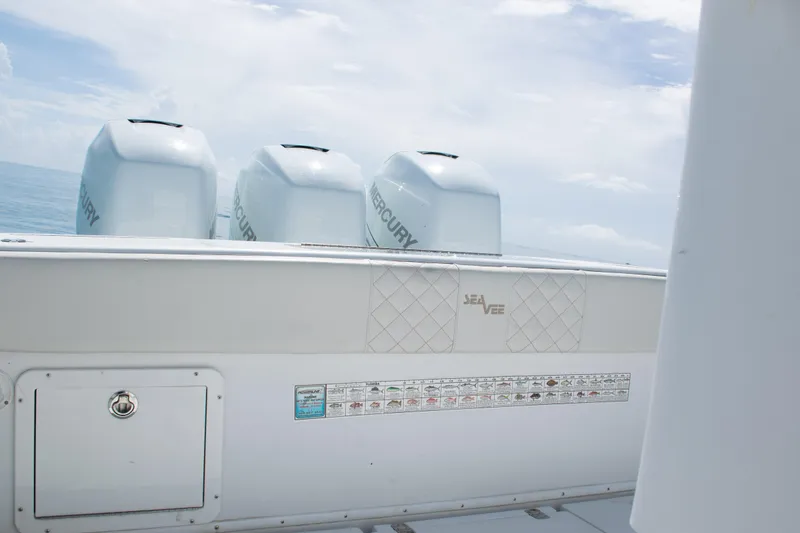 Slide: The Image of 2006 SeaVee 340B boat with Mercury engines, ocean backdrop, and fishing guide. - 32