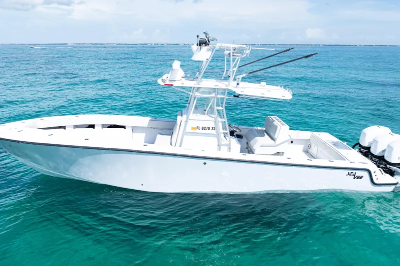 Slide: The Image of 2006 SeaVee 340B boat on clear turquoise water, featuring a sleek white design. - 37