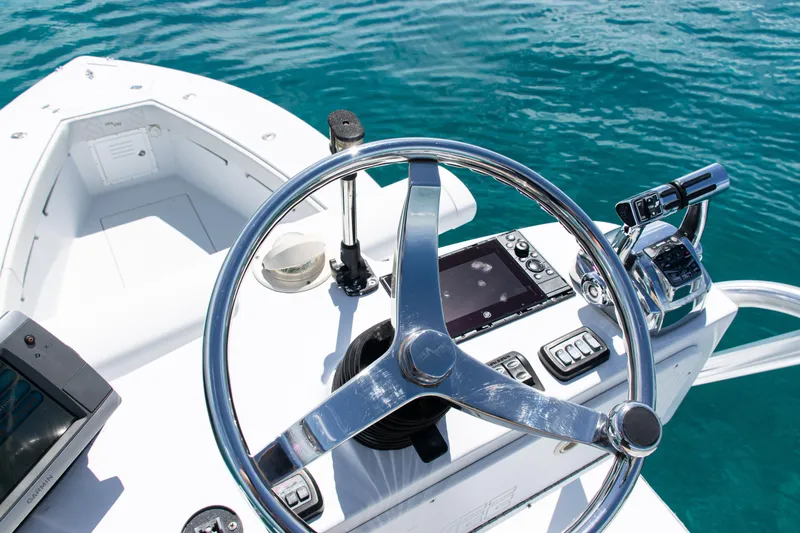 Slide: The Image of Steering console of a 2006 SeaVee 340B boat on clear blue water. - 39