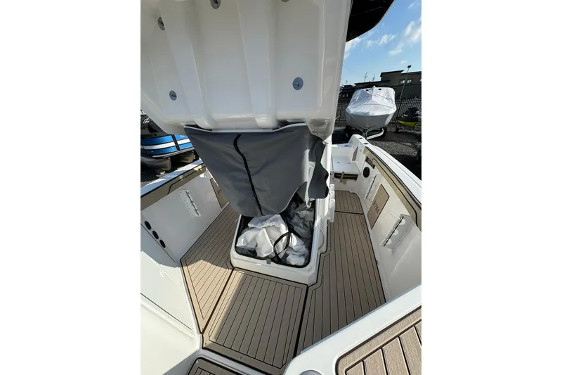 Slide: The Image of 2026 Yamaha Boats 222 FSH Sport E interior with steering wheel and seating. - 14