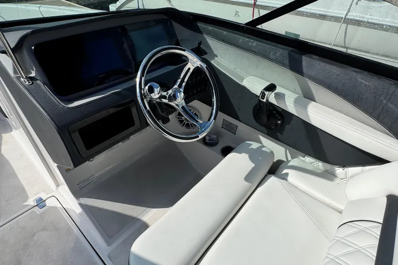 Slide: The Image of 2024 Regal LX6 boat interior with sleek steering wheel and modern dashboard design. - 13