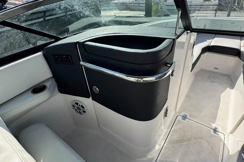 Slide: The Image of 2024 Regal LX6 boat interior with seating, cup holder, and speaker. - 19