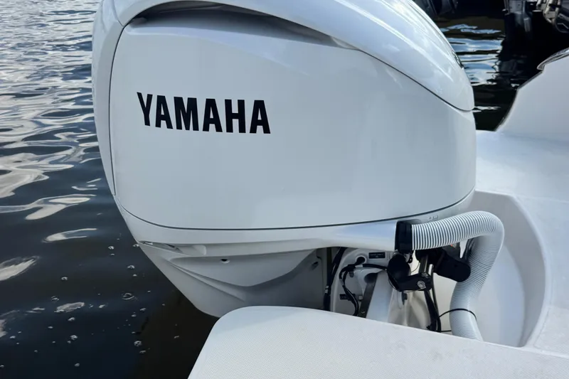 Slide: The Image of 2024 Regal LX6 boat with Yamaha outboard motor on water. - 6