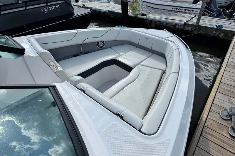 Slide: The Image of 2024 Regal LX6 boat with spacious white seating at a dock. - 8
