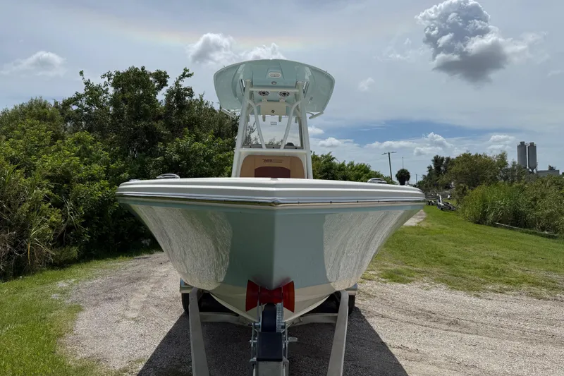 Slide: The Image of 2026 Pathfinder 2400 TRS boat on trailer, parked outdoors under a cloudy sky. - 10