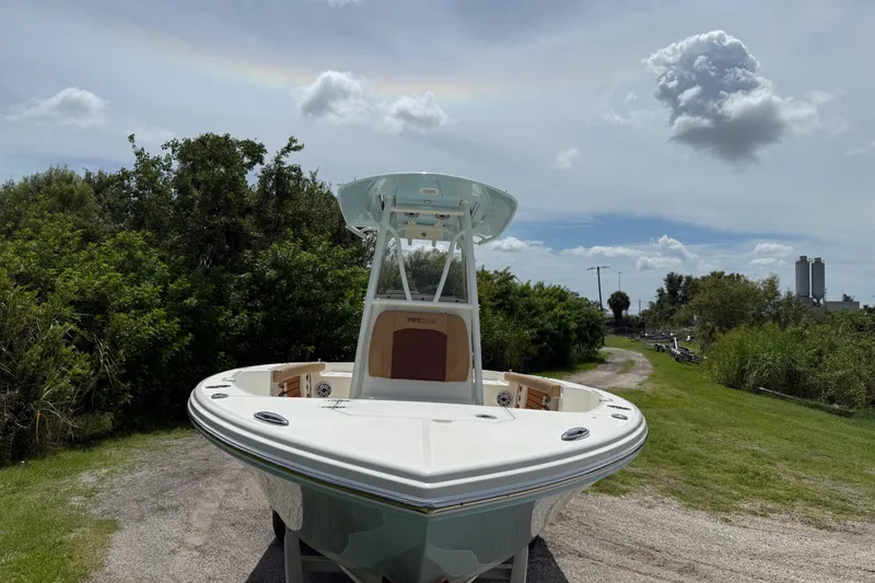 Slide: The Image of 2026 Pathfinder 2400 TRS boat on a grassy path under a cloudy sky. - 11