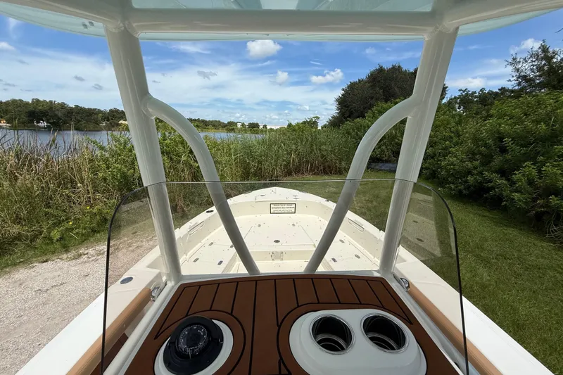 Slide: The Image of 2026 Pathfinder 2400 TRS boat with scenic lake and greenery in the background. - 16