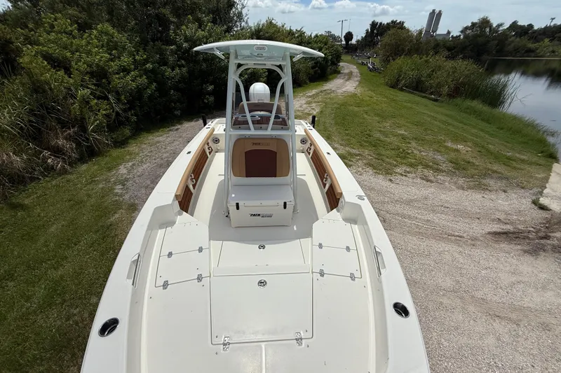 Slide: The Image of 2026 Pathfinder 2400 TRS boat on grassy shore, showcasing spacious deck and sleek design. - 19
