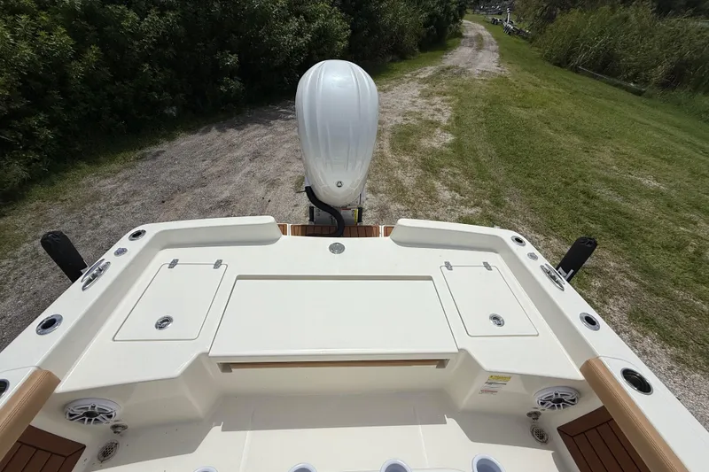 Slide: The Image of 2026 Pathfinder 2400 TRS boat with outboard motor on grassy path. - 23