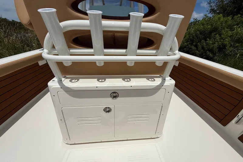 Slide: The Image of 2026 Pathfinder 2400 TRS boat interior with rod holders and storage compartment. - 26