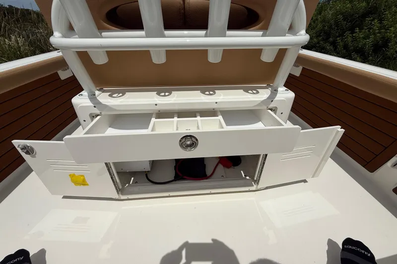 Slide: The Image of 2026 Pathfinder 2400 TRS boat storage compartment with open drawers and seating. - 27